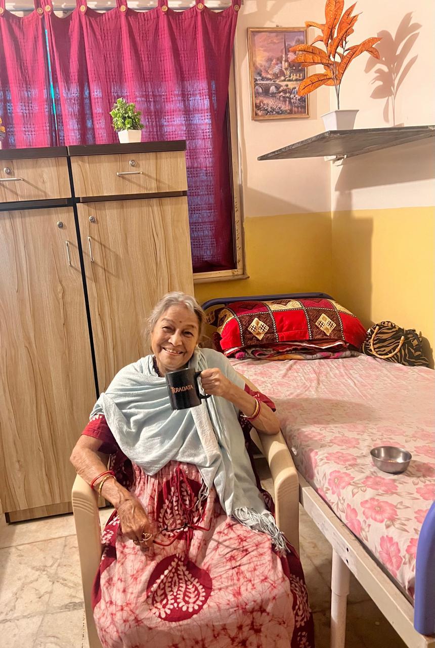 A happy, well-cared-for senior enjoying tea at the Patient Care Unit in Thane West